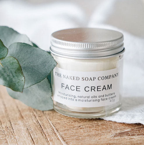 Glass jar of the naked soap company all natural and plastic-free face cream.