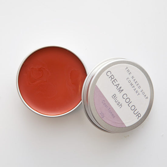 1 opened tin of zero waste cream colour blush, reddish in colour. On a white background.
