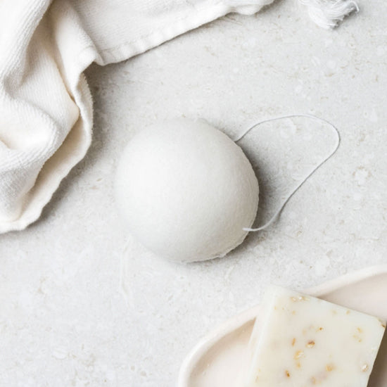 Load image into Gallery viewer, 1 round all-natural zero-waste konjac sponge. On a benchtop.
