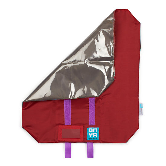 Red reusable zero waste lunch wrap with corner folded over. Red on the inside with velcro straps. On a white background.