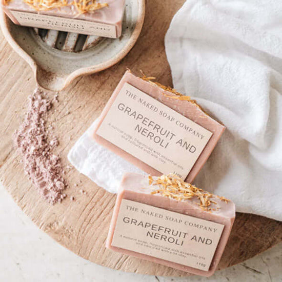 2 gorgeous naked soap bars - Grapefruit and Neroli - on a benchtop.