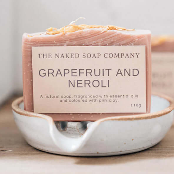 The naked soap company grapefruit and neroli non toxic body soap on a soap dish.