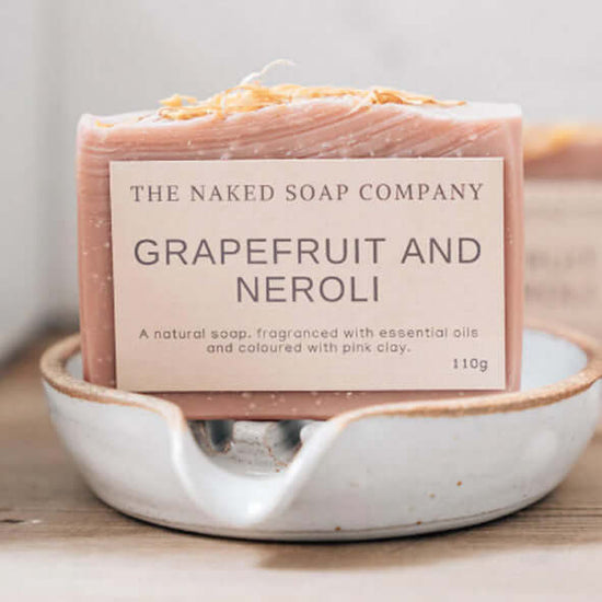 Load image into Gallery viewer, The naked soap company grapefruit and neroli non toxic body soap on a soap dish.
