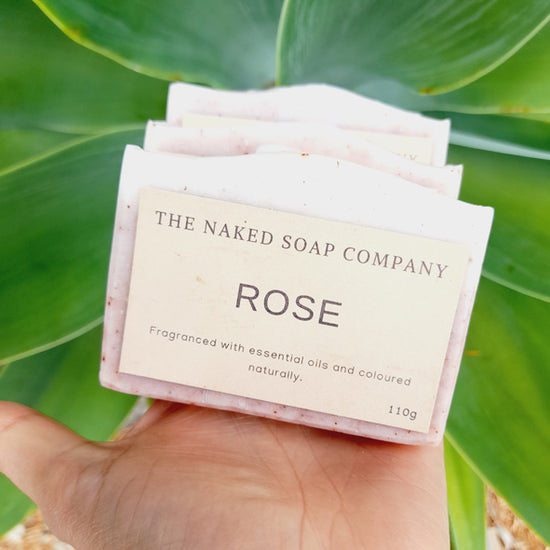 Load image into Gallery viewer, Someone holding 3 bars of The Naked Soap Company Vegan &amp;amp; All natural Rose soap bar. Plastic-free.
