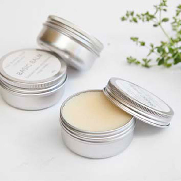 3 Aluminium tins of all natural basic balm on a white background