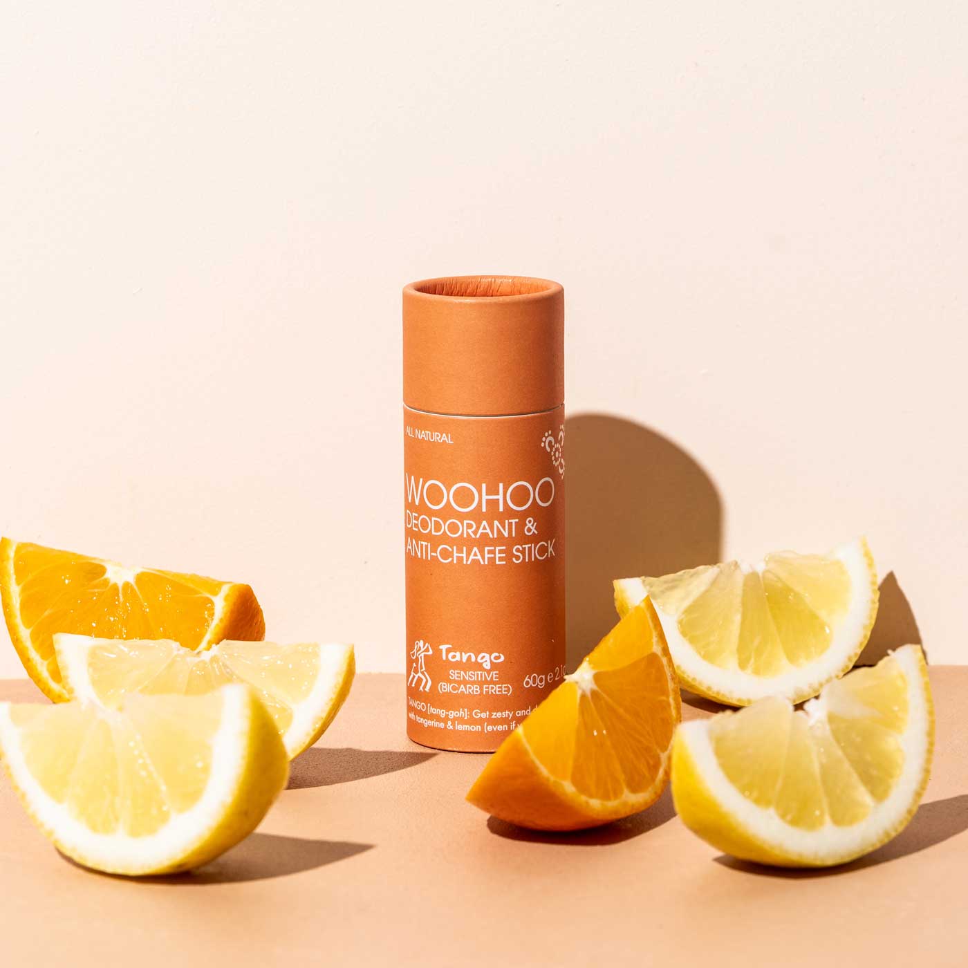Load image into Gallery viewer, Bar of Woohoo Body&amp;#39;s all natural and plastic free deodorant and anti chafe stick - tango. Surrounded by citrus slices.
