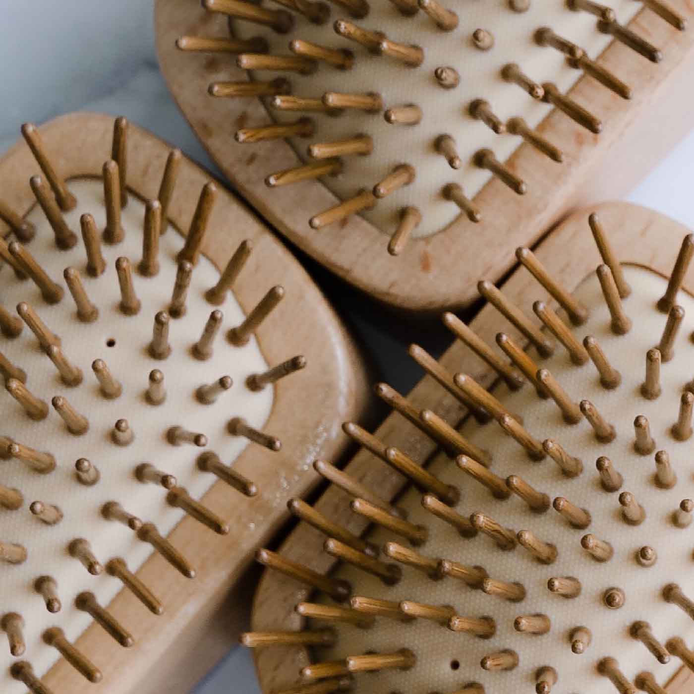 Close up of zerocare haricare eco detangler brush made from bamboo and natural rubber.