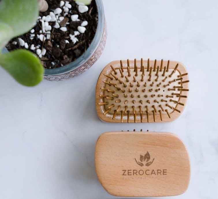 Load image into Gallery viewer, Zerocare haircare eco detangler brush. Made with bamboo and natural rubber. ON a white benchtop.
